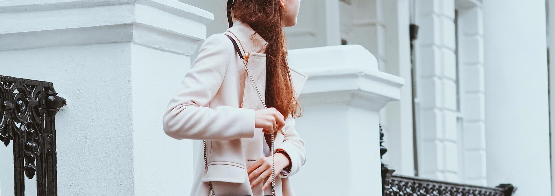 woman with pink coat and purse