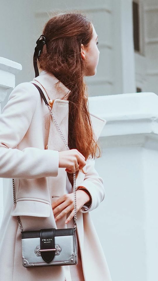 woman with pink coat and purse