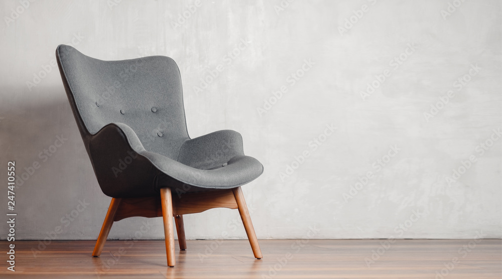 Gray chair in white concrete room for copy space. Concept of minimalism