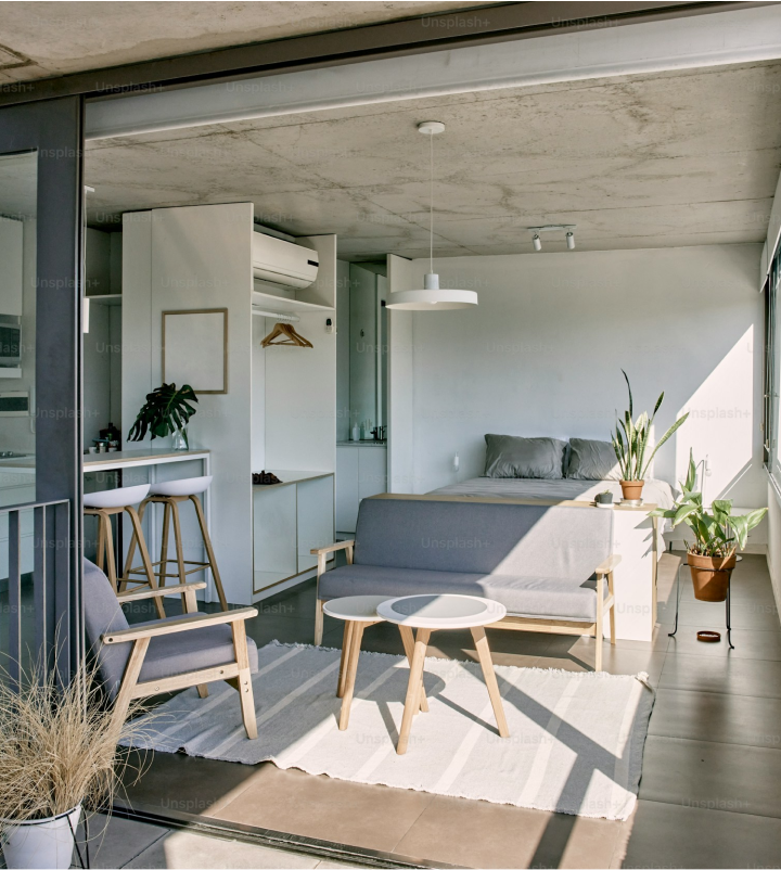 a balcony with a couch, table and chairs at The Stinger