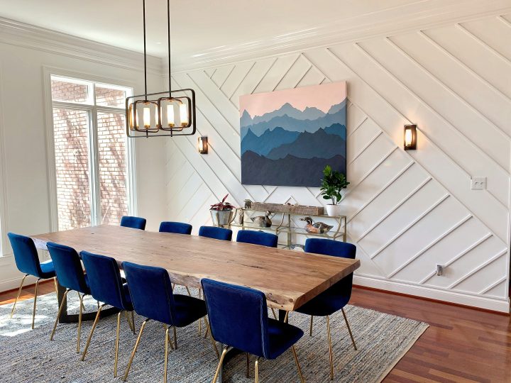 a dining room with blue chairs and a wooden table at The Stinger