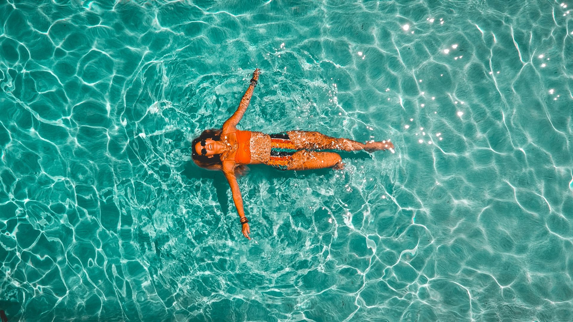 a woman in a swimsuit floating in the water at The Stinger